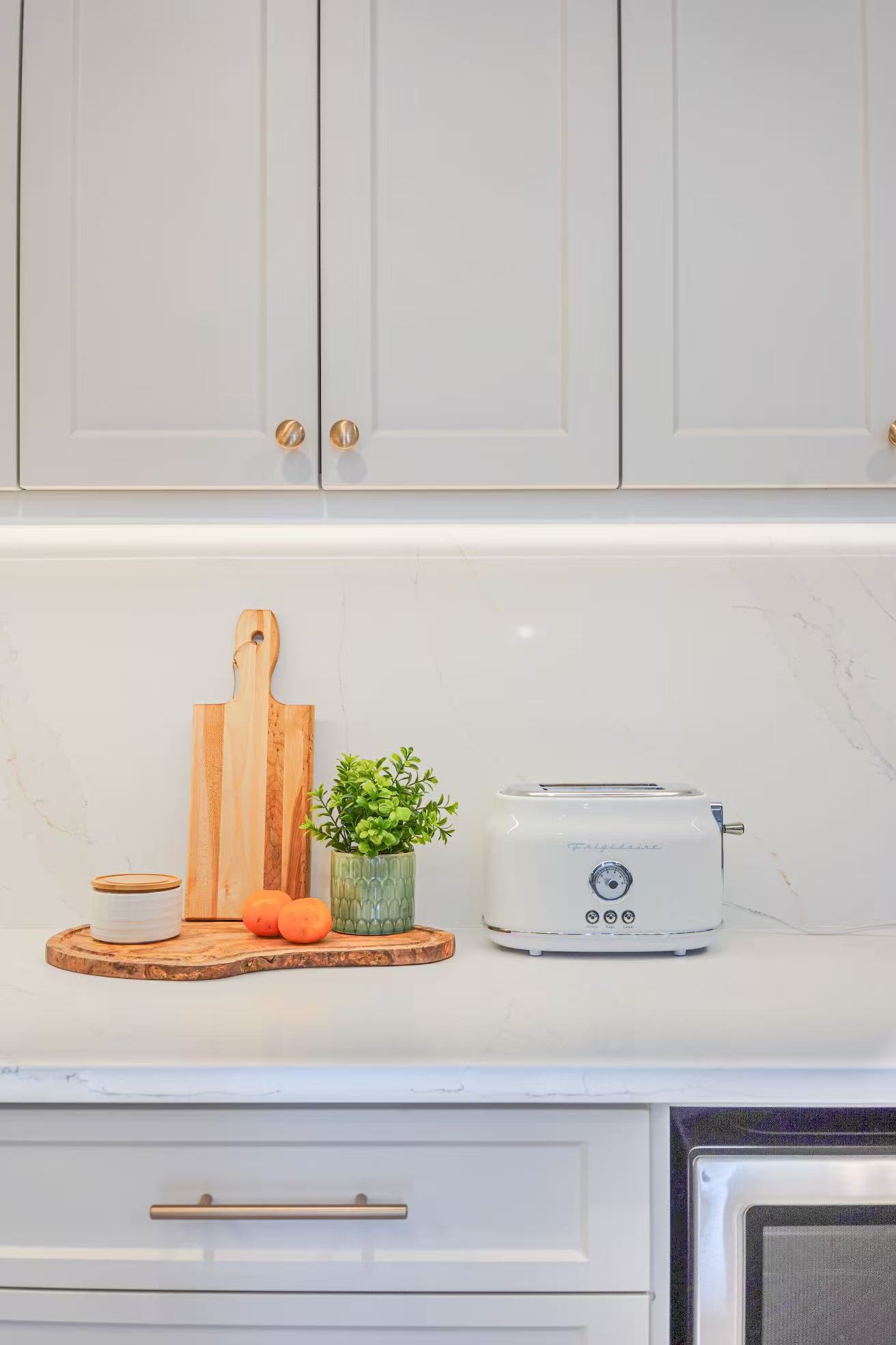 Close-up of white cabinet doors and countertop styling