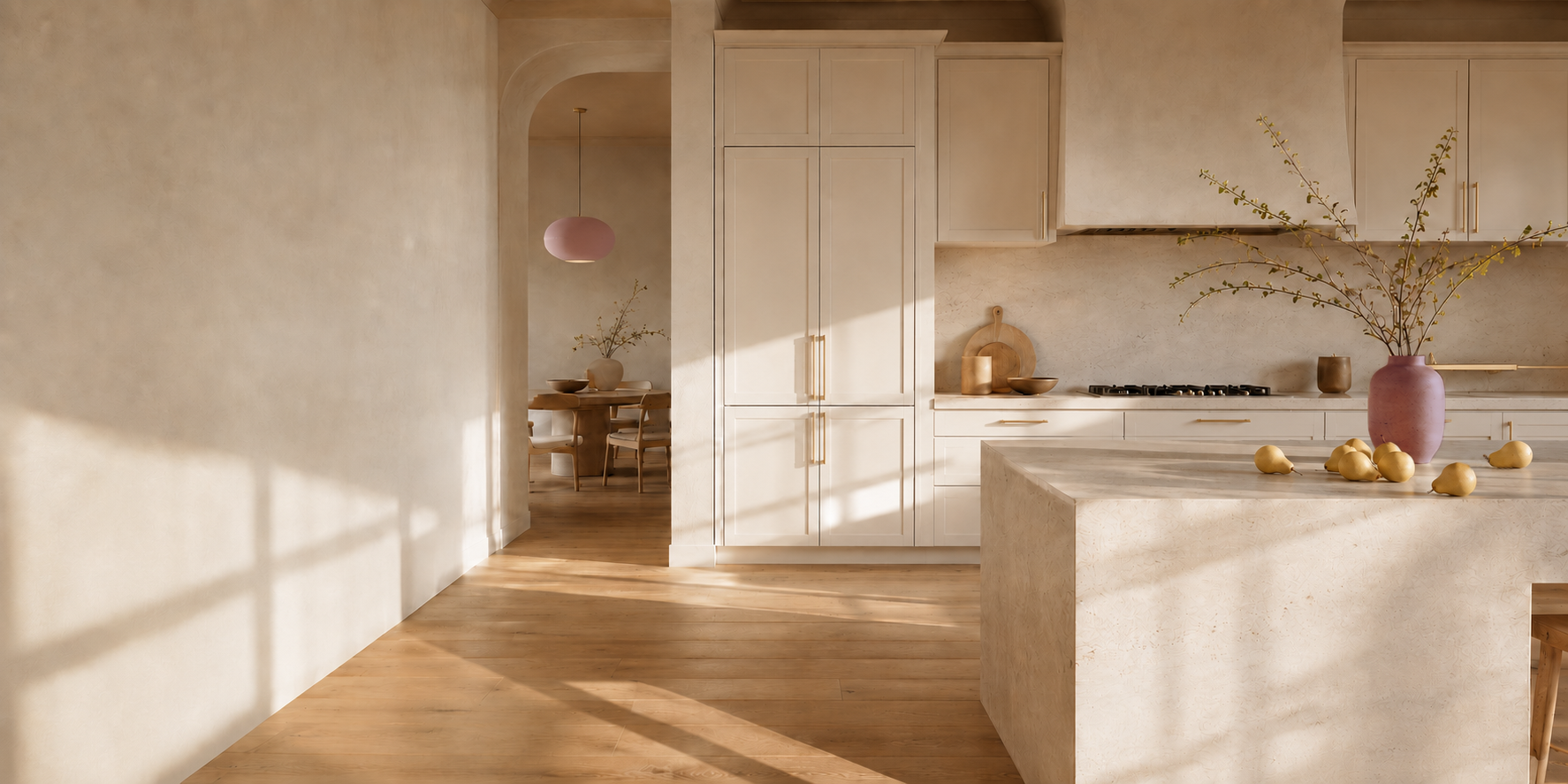 Warm custom kitchen with cream cabinetry and a stone island