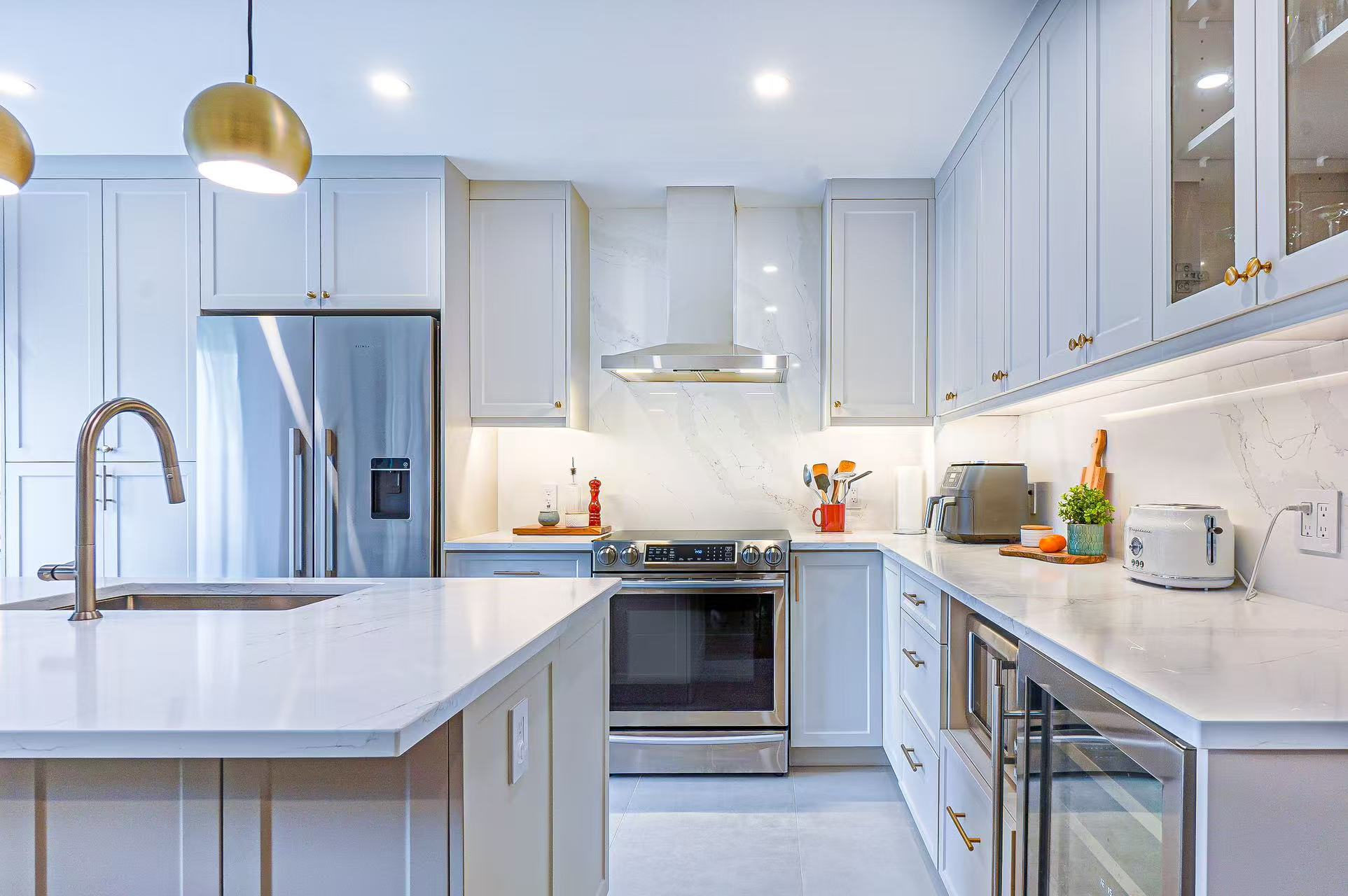 Bright white kitchen with custom cabinetry and stone counters